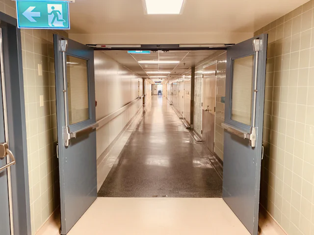 Slip-resistant sheet vinyl floor with coved base in a clinic corridor